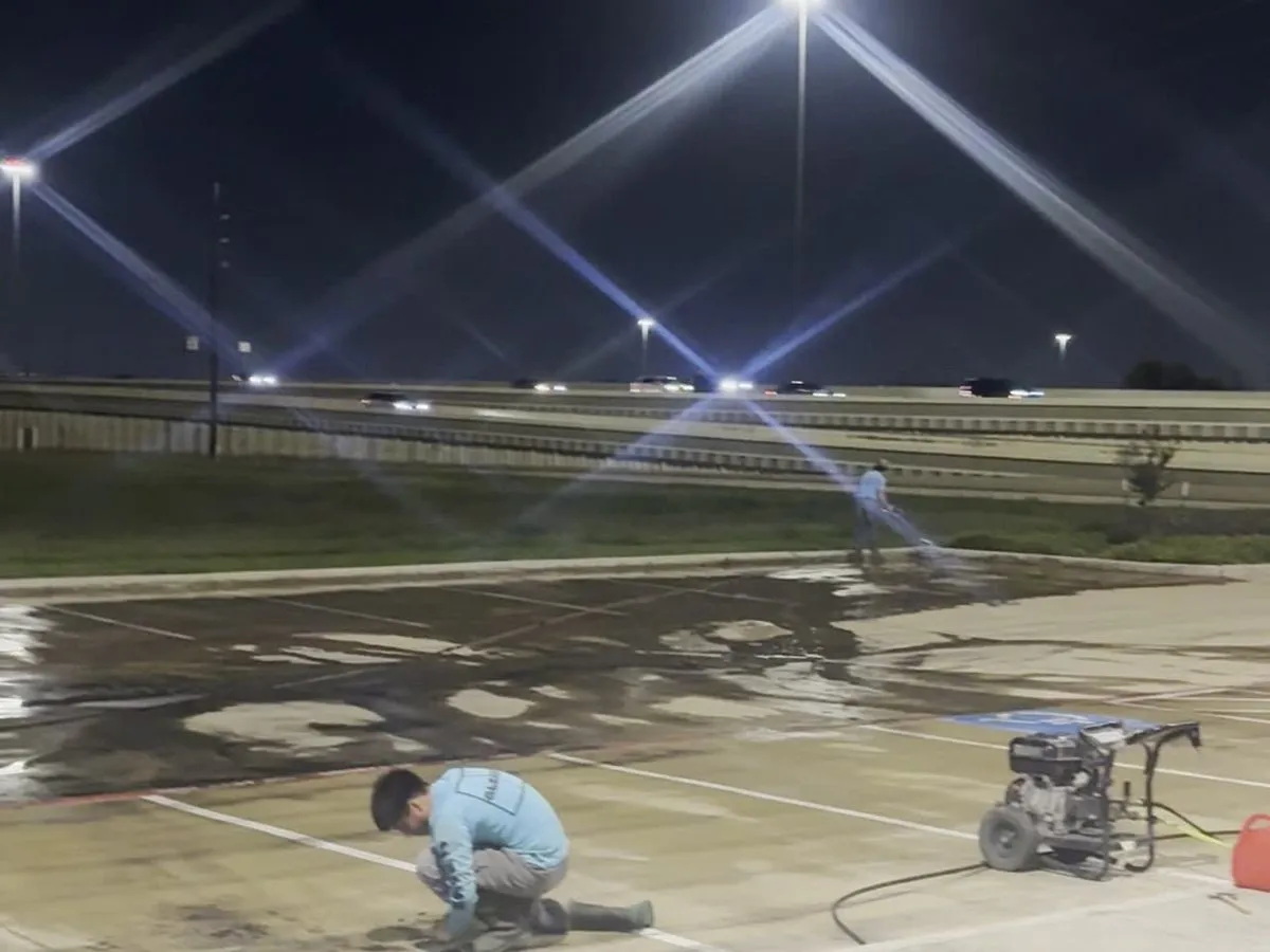 Gleam Clean commercial crew cleaning a concrete entry area at night
