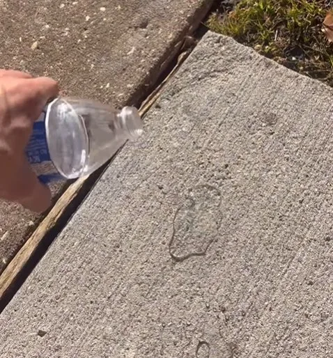 Water test on concrete showing how driveway sealing affects absorption.