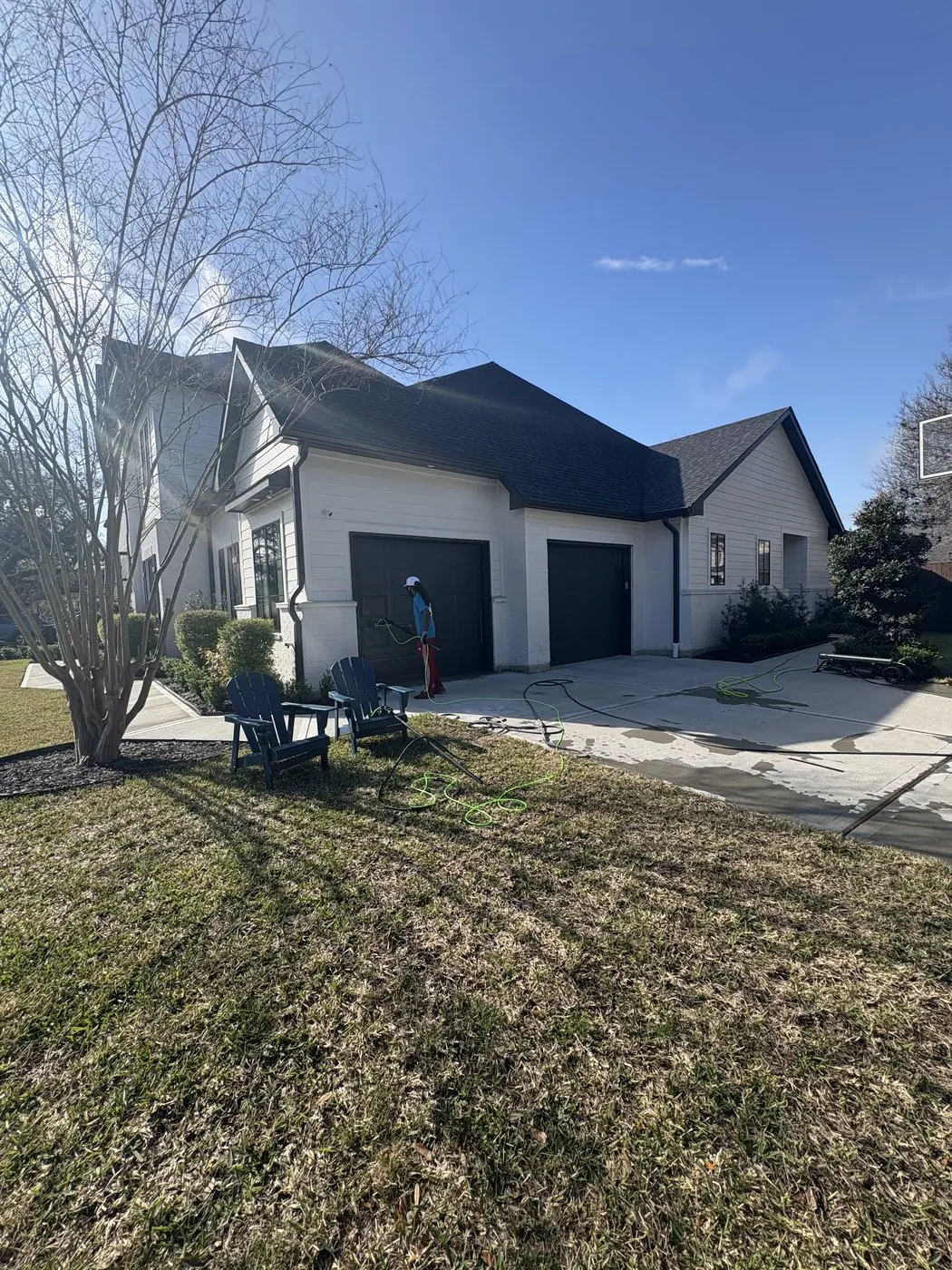 Modern Houston home exterior with cleaning equipment staged for service.