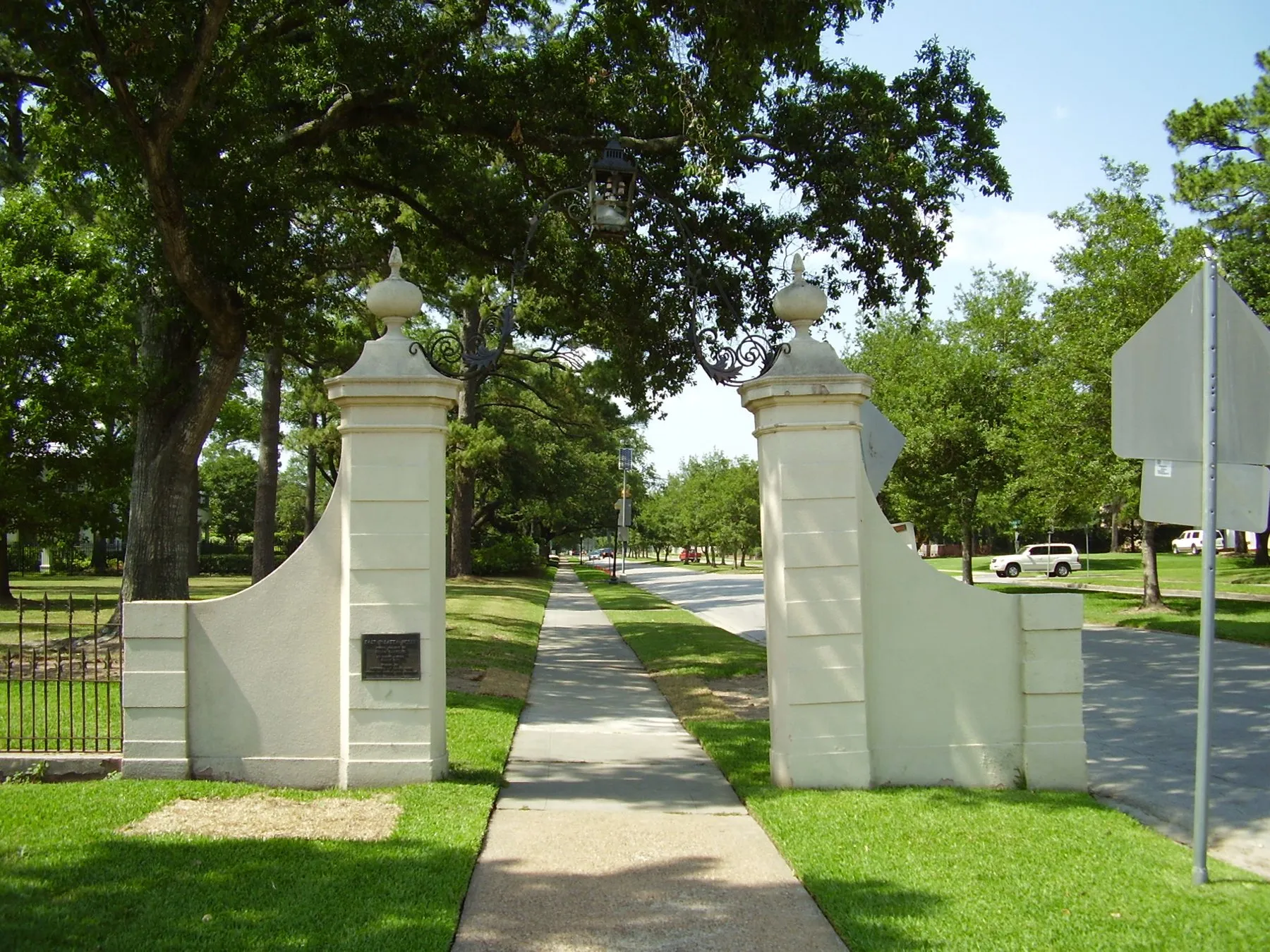 River Oaks neighborhood entry marker under mature Houston trees